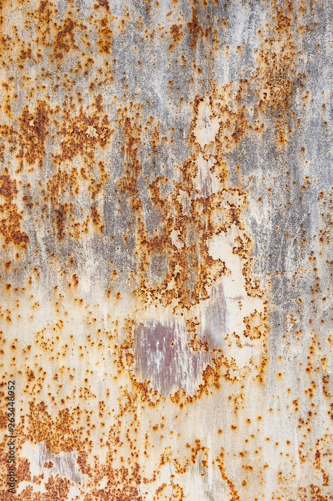 Background textures of old rusty damaged metal. Remains of multi-colored paint on an iron sheet.