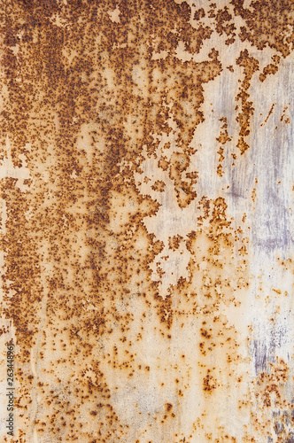 Background textures of old rusty damaged metal. Remains of multi-colored paint on an iron sheet.