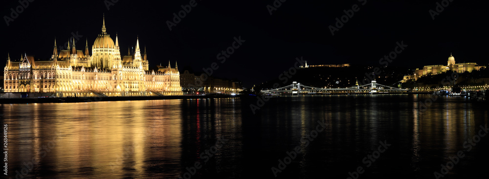 Budapest night panorama with illuminated parliament, chain bridge and castle.