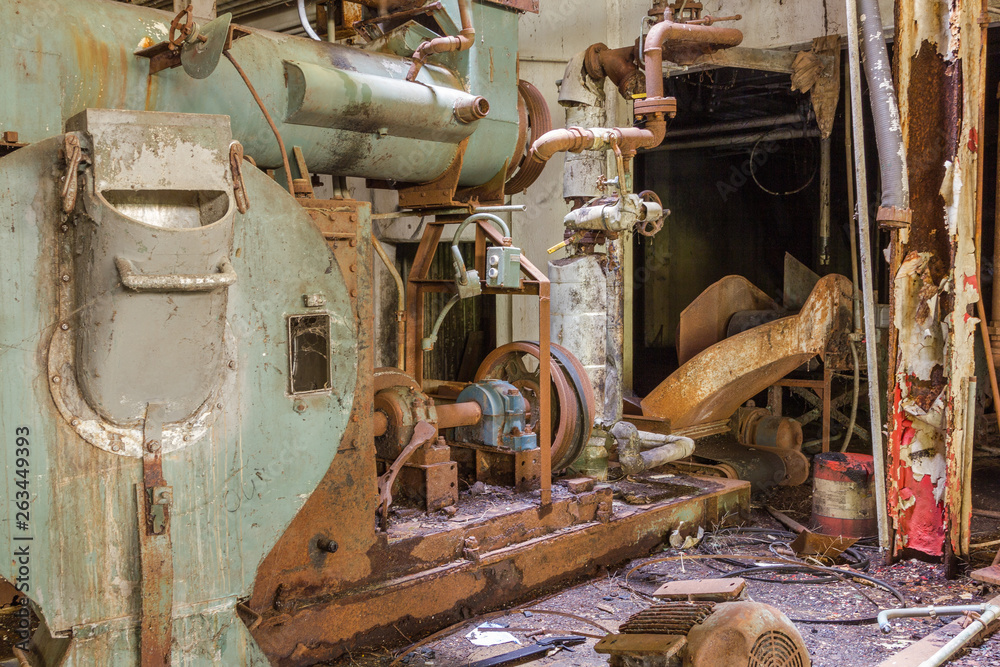 Abandoned machinery in a long forgotten factory with grunge and grime