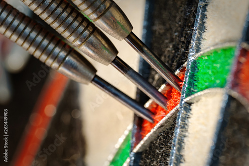 Canvas Print Close up view on a three darts in triple twenty sector of sisal dartboard