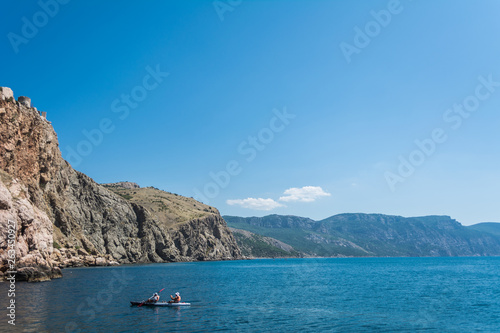 Sea Kayaking in calm waters during a colorful and vibrant sunny day. Beautiful seascape. Adventure couple. Travel Photo
