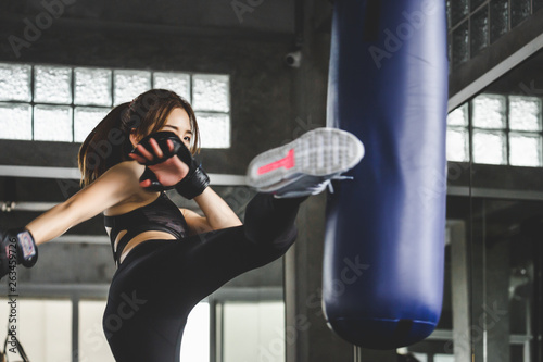 Athlete woman doing kick boxing training © Peera