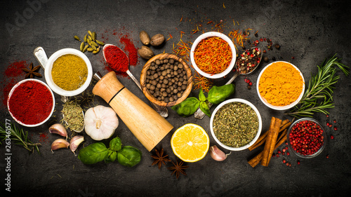 Fototapeta Naklejka Na Ścianę i Meble -  Set of various spices on black background.