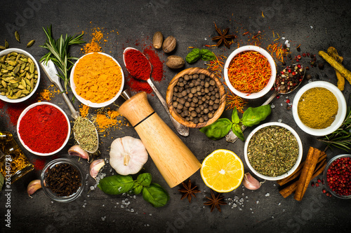 Set of various spices on black background.