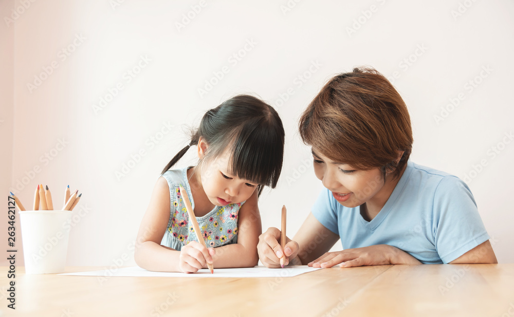 Happy Asian Mother and daughter drawing together. Happy Asian Mother and daughter drawing together.