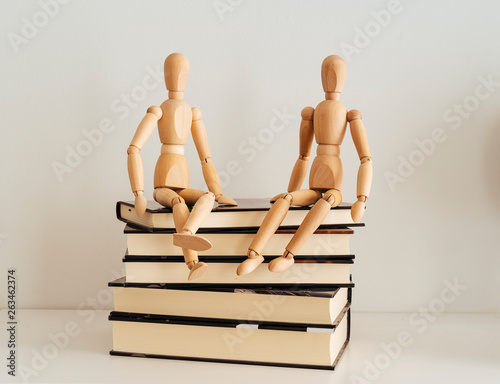 Wooden figures celebrating friendship on a books closed, culture bookday photo