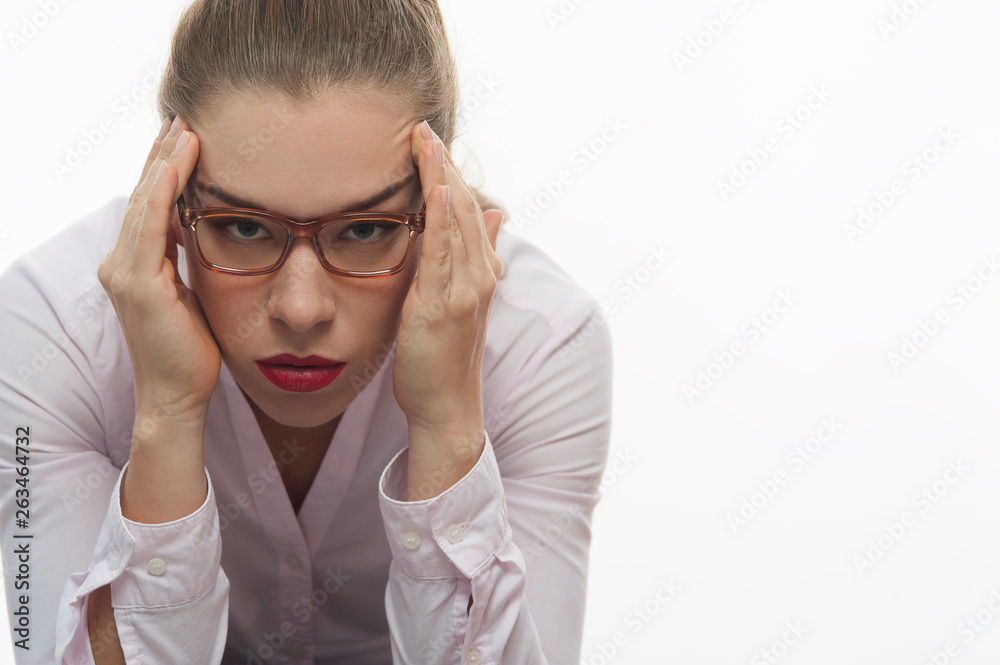 Stressed woman in pink blouse holding her head Stressed woman in pink blouse holding her head