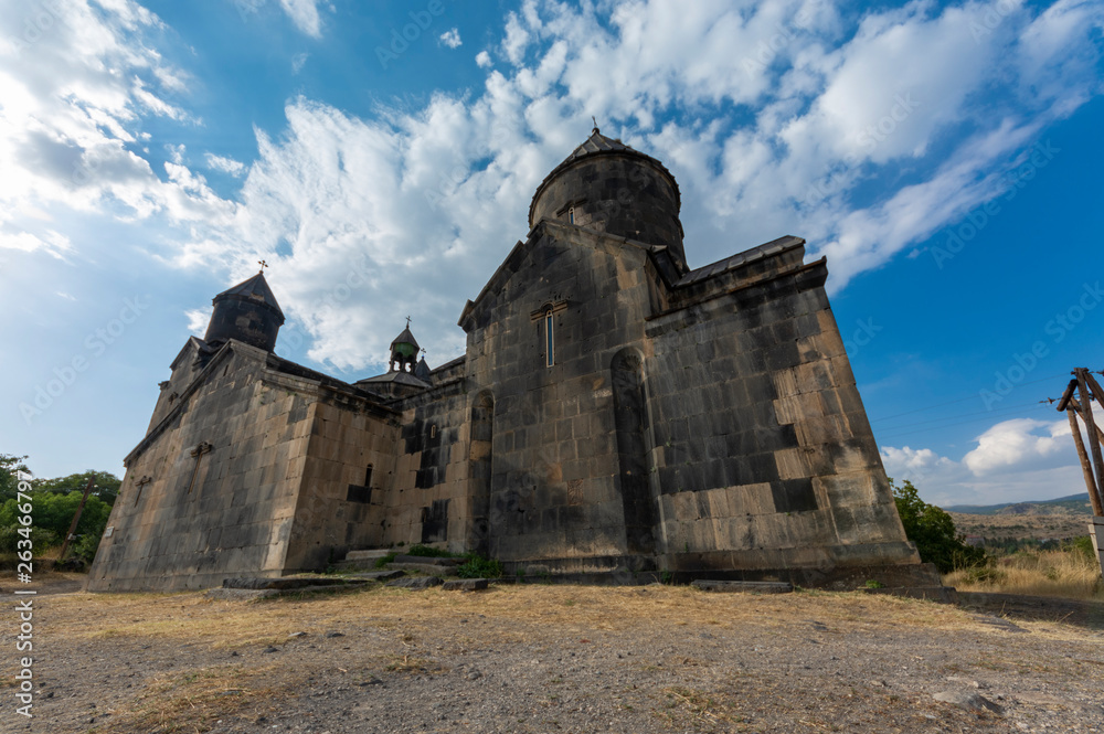 Armenian old church, beautiful blue sky and clouds.