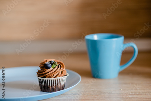 decorated tasty Cupcake with slice of Strawberry and Chocolate on the table. Horizontal view several objects