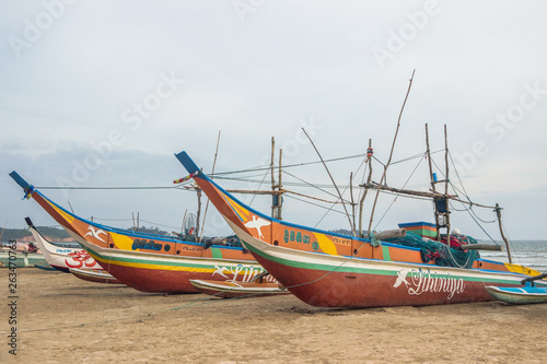colorful wooden fishing boat on beach in Sri Lanka 