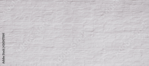 White painted plastered vintage old brick wall. Background for text or image. 