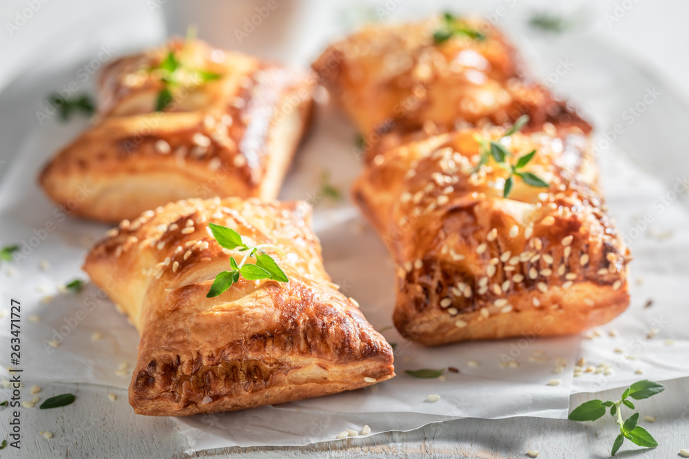 Hot sausage in puff pastry with thyme and sesame seeds