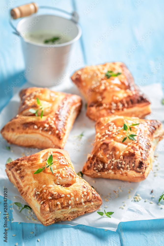 Tasty sausage in puff pastry with thyme and sesame seeds Tasty sausage in puff pastry with thyme and sesame seeds