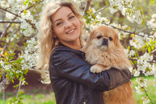 Nice woman with cute dog at garden . Pet adoption, life of pets. Female carrying a pet , animals healthy happy canine adorable breed 
