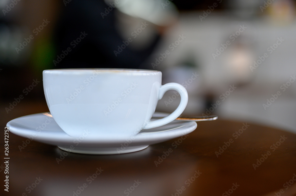 Fototapeta White coffee mug placed on the desk