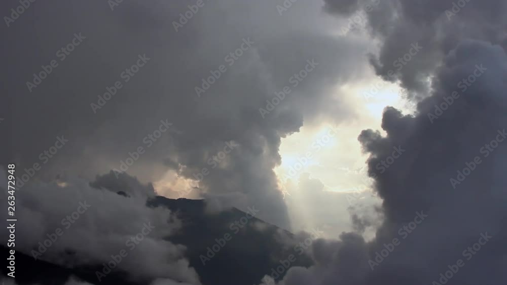 Tilting down to view a dramatic dawn through pillars of cloud over the Himalayan mountains. Tilting down to view a dramatic dawn through pillars of cloud over the Himalayan mountains.