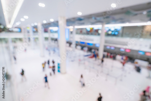 abstract blur image background of public hall in airport temrminal with crowd of traveller