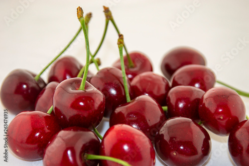 Red, ripe cherries on a white background