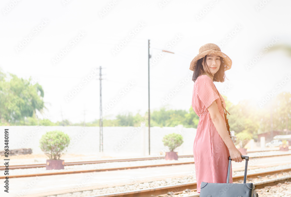 Hipster girl waiting train with leather vintage bag