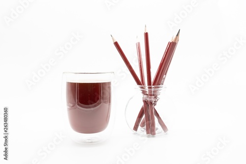 a glass of coffee and pencils, isolated on a white background