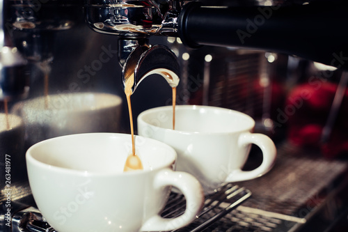 Barista using coffee machine in the cafe.