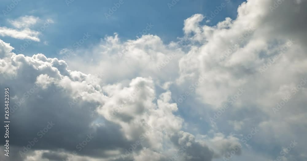 Time lapse clip of gray fluffy curly rolling clouds before storm in windy weather with sun rays Time lapse clip of gray fluffy curly rolling clouds before storm in windy weather with sun rays
