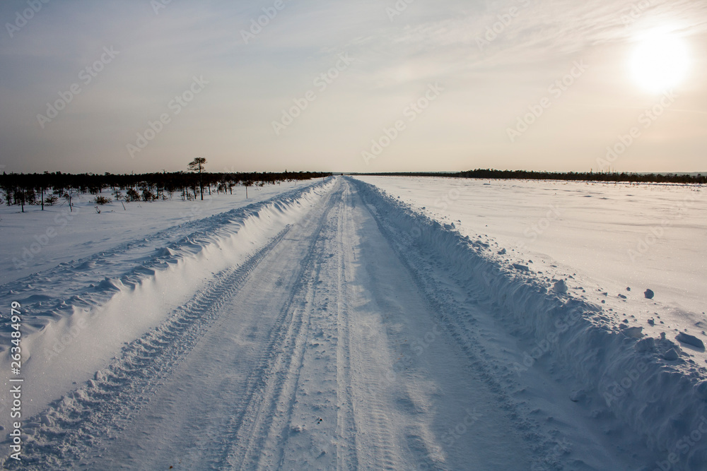 Winter road in the field going into the horizon. Siberia. Landscape. Winter road in the field going into the horizon. Siberia. Landscape.