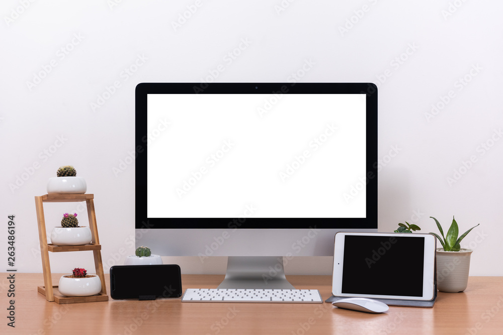 All in one computer, mouse, keyboard, smart phone, tablet, cactus pots and plant vase  on wooden table