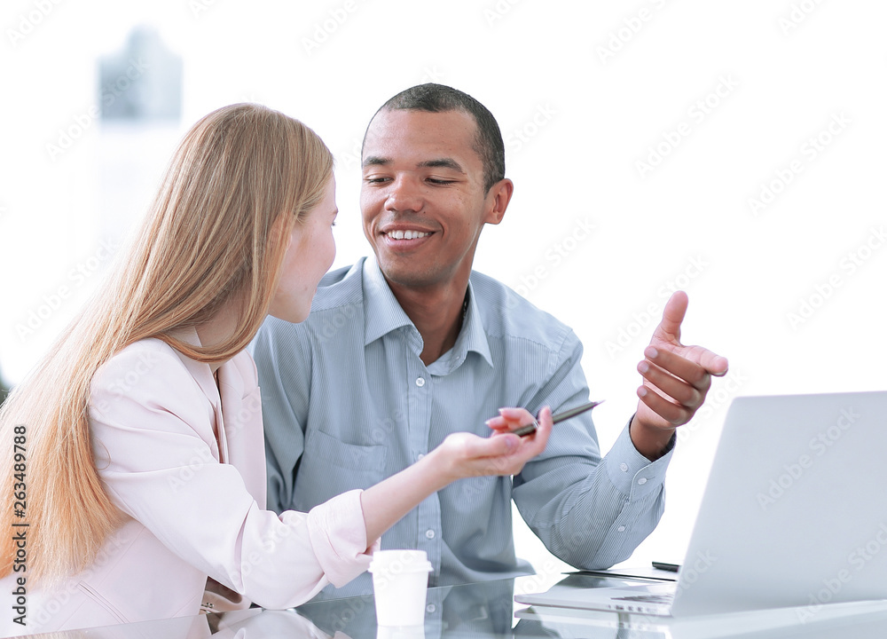 Beautiful young business partners are using a laptop, discussing documents Beautiful young business partners are using a laptop, discussing documents