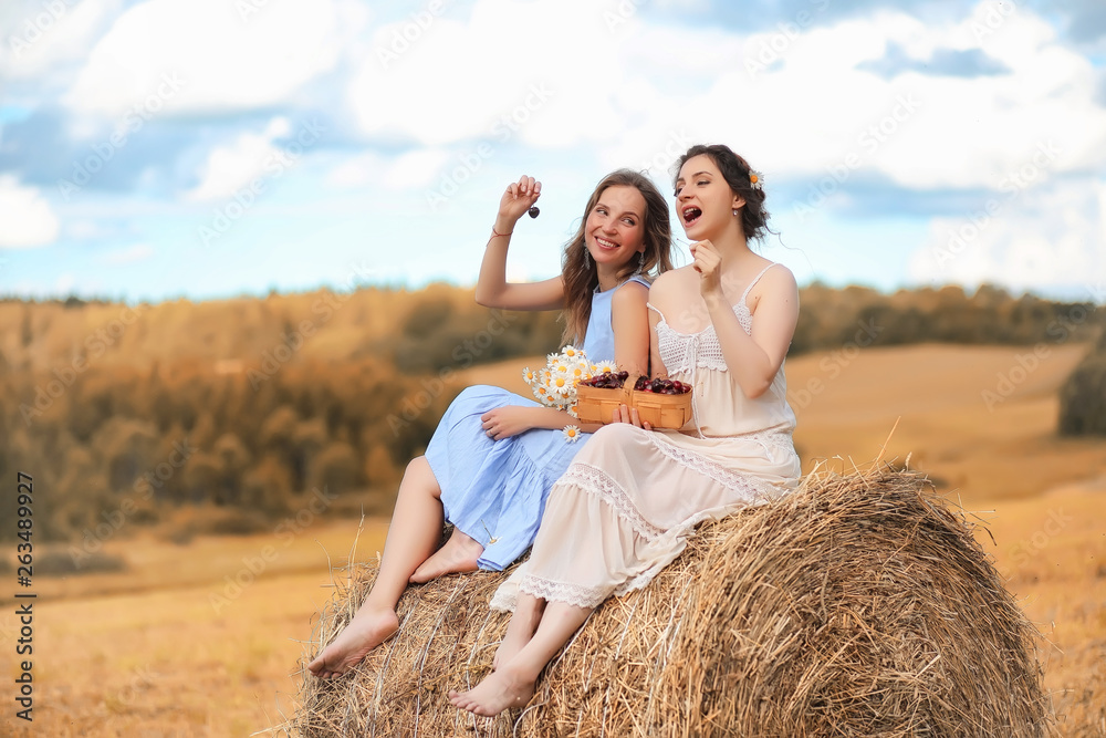 Two girls in dresses in autumn field Two girls in dresses in autumn field