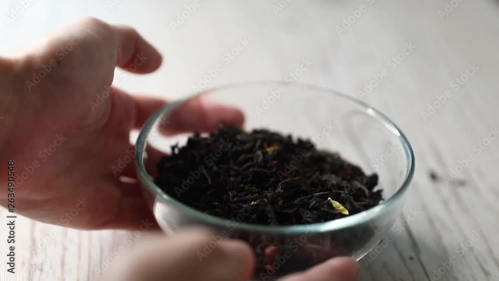 Dry flavoured black tea on a wooden background. Close-up, copy space. Dry flavoured black tea on a wooden background. Close-up, copy space.