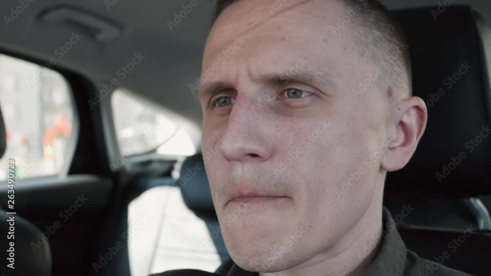 Portrait of a man sitting in a car. He's upset. Portrait of a man sitting in a car. He's upset.