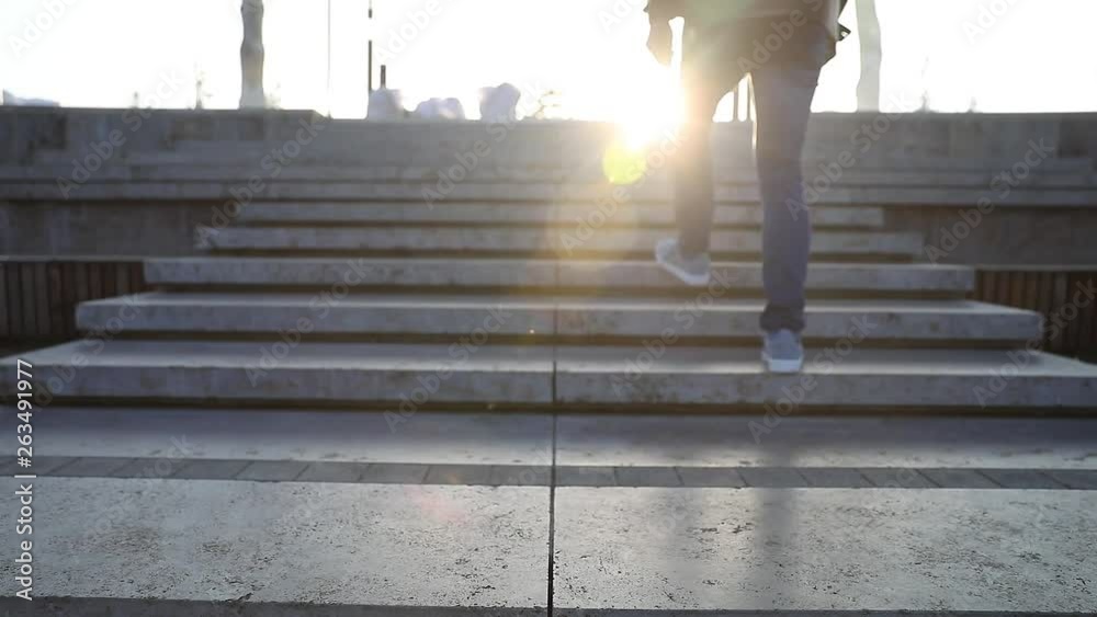  Mature man coming down a staircase, silhouette in rays of lights, soft focus