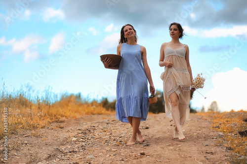 Two girls in dresses in autumn field © alexkich