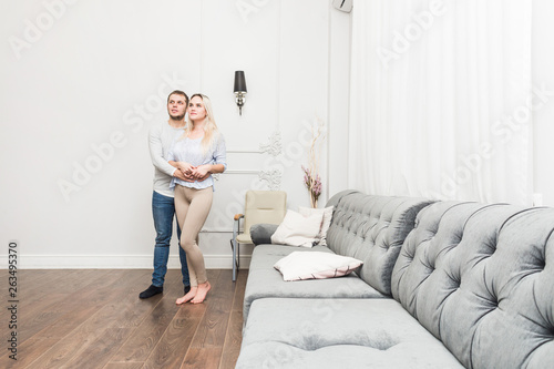 Lovely young couple in a living room with a modern interior.