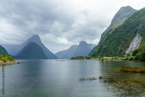 mountains in the fog at famous natural wonder milford sound, new zealand 2