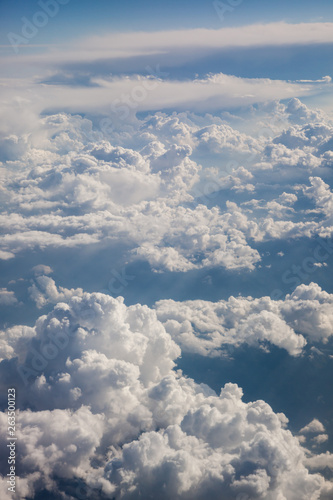 Fototapeta Naklejka Na Ścianę i Meble -  Fluffy white clouds, a view from airplane window