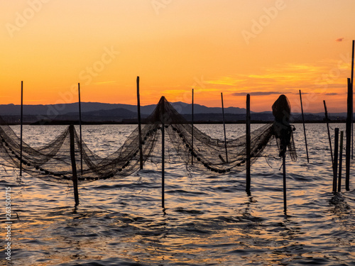 Sunset on the lake in Albufera, Spain, fishing nets © Svetlana