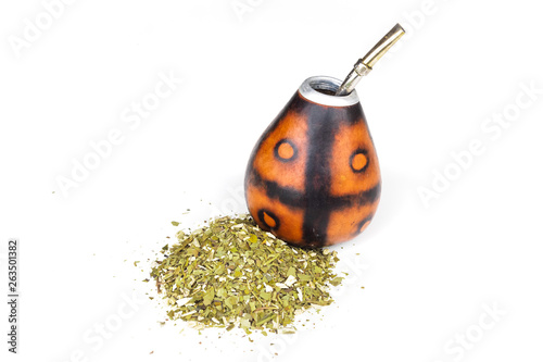 Calabash for yerba mate with its bombila with a lot of yerba mate on a white background photo
