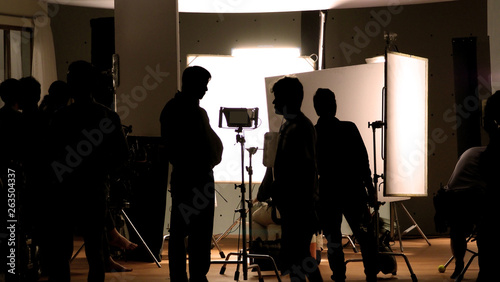 Obraz na płótnie Shooting studio behind the scenes in silhouette images which film crew team work
