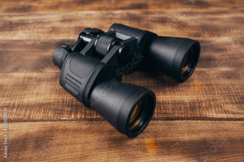 Binoculars on the wooden table