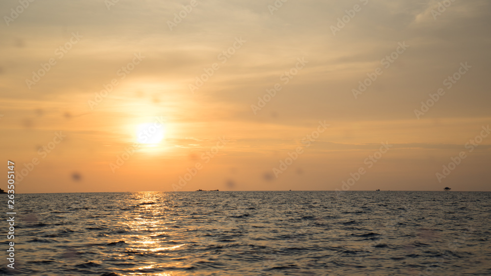 Landscape of beautiful sunset in Phu Quoc island sandy beach with colorful sky and dramatic clouds over wavy sea	