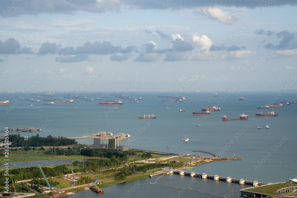 Singapore anchorage area panorama opposite Gardens by the Bay with many ships on an anchorage	