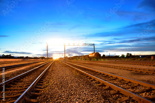 Cargo train platform at sunset with container