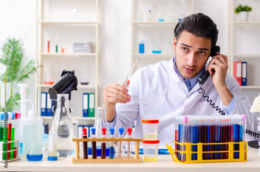 Young male chemist working in the lab Young male chemist working in the lab