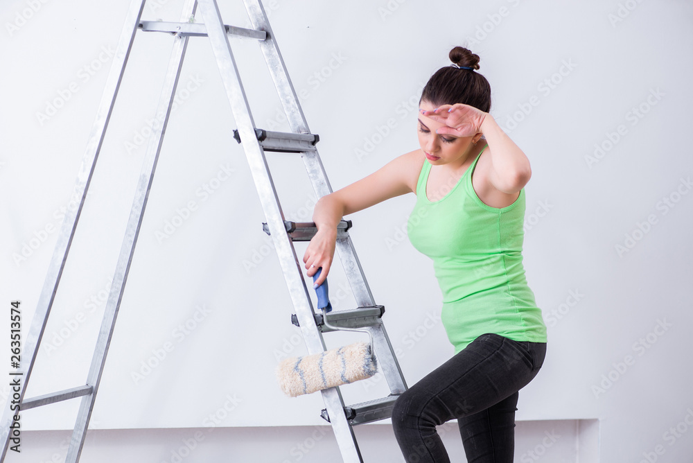 Young beautiful woman doing renovation at home Young beautiful woman doing renovation at home