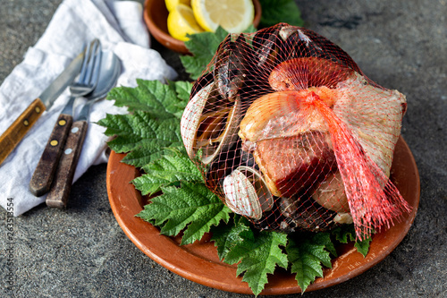 Famous traditional dish of the south of Chile and the Chiloe archipelago - Curanto al Hoyo, Kuranto.  Different seafood,  meat and potatoes milcao cooked in a pit on the coals under the ground photo