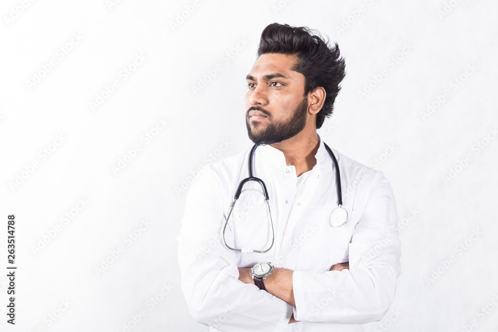 Handsome young doctor in a white coat with a stethoscope. Health care concept. Handsome young doctor in a white coat with a stethoscope. Health care concept.