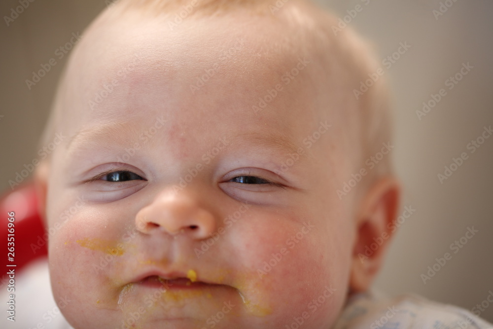 A child of 6 months pedagogical feeding from a spoon of porridge. A child of 6 months pedagogical feeding from a spoon of porridge.